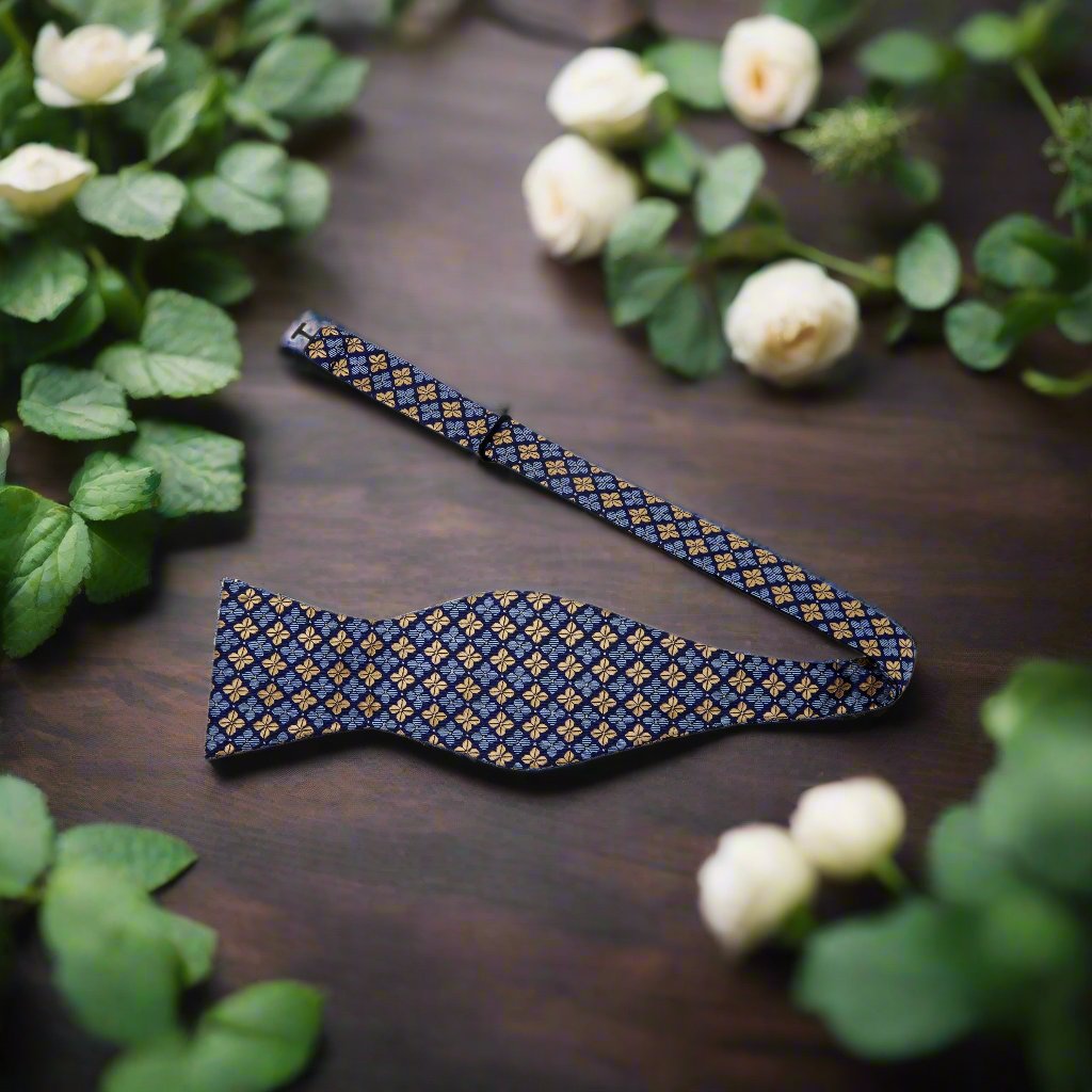 Close-up of floral silk bow tie with blue and gold clover pattern, suitable for weddings