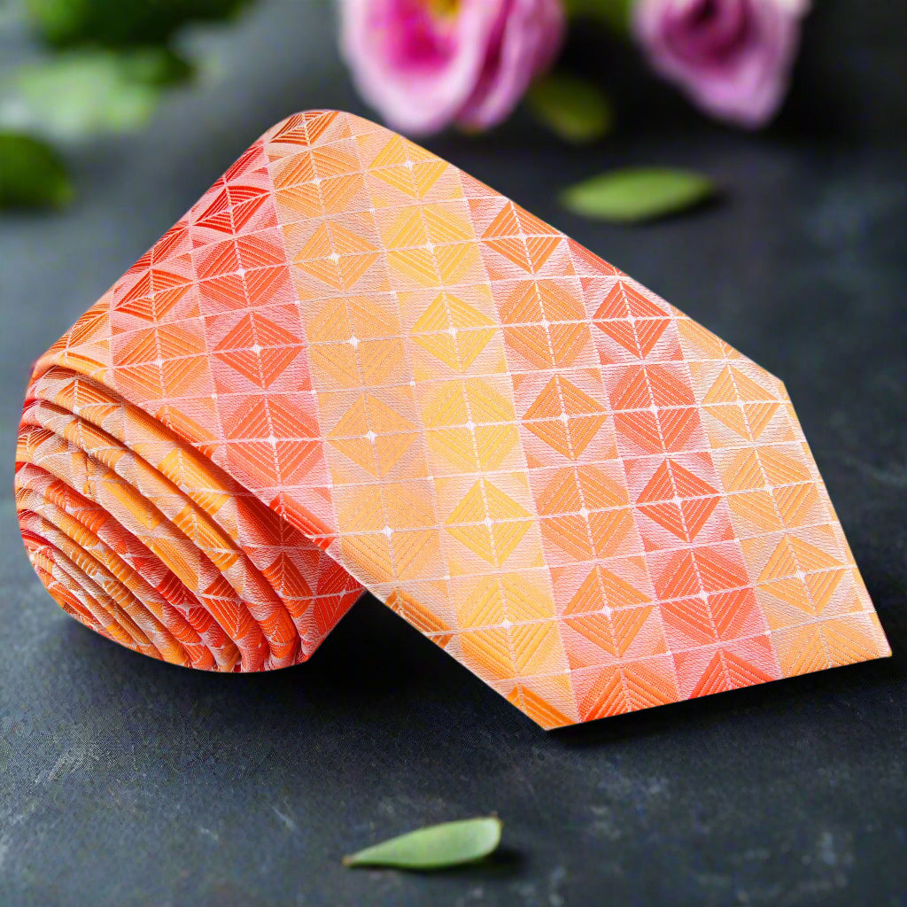 Vibrant orange geometric silk tie displayed on a white background.