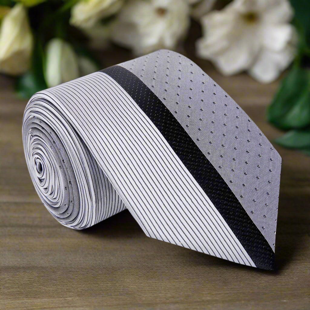 Close-up of the Adagio silver silk tie showing its black lined pattern and smooth texture