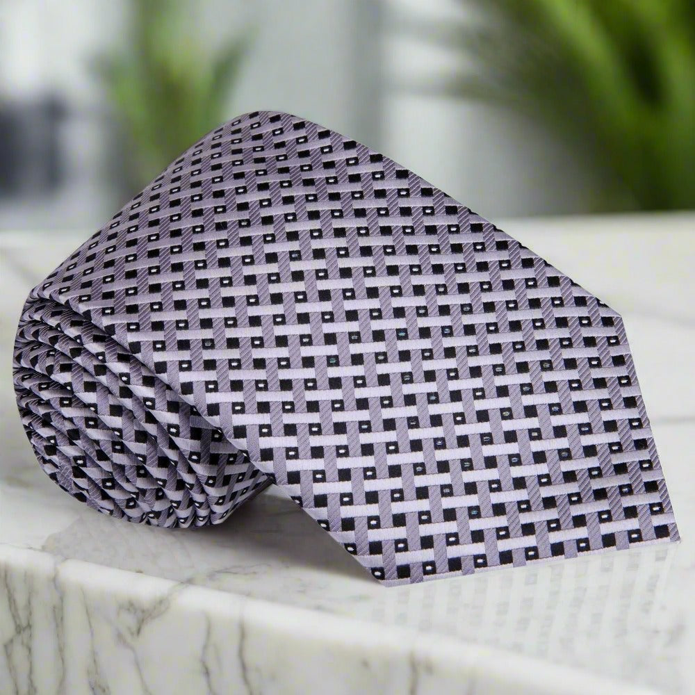 The gold silk necktie paired with a navy suit and white dress shirt for a sophisticated look.