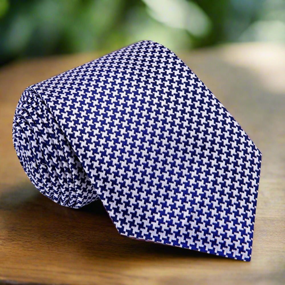 Matching pocket square in gold and black houndstooth design complementing the necktie