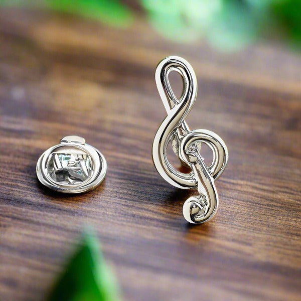 Close-up angle of music lapel pin showing treble clef and drum detailing — perfect as a treble clef pin for music teachers.