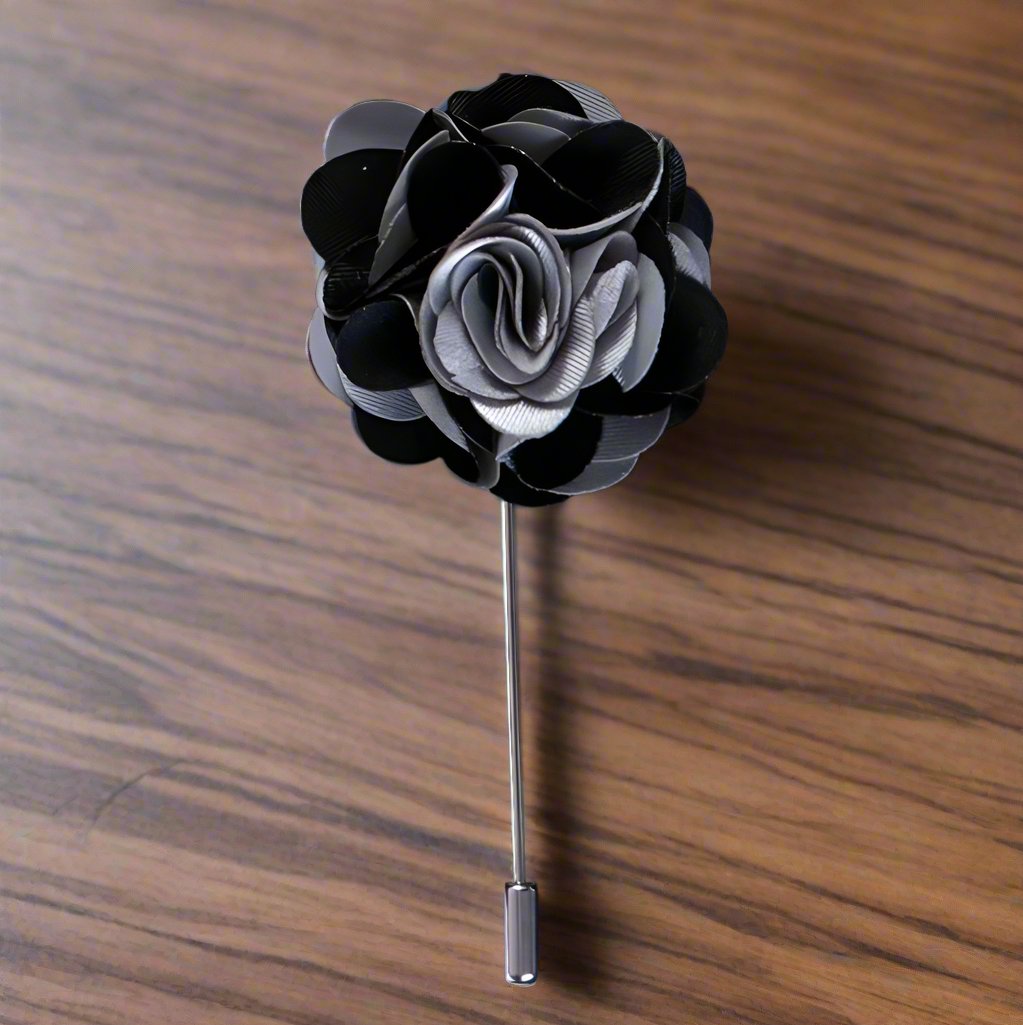 Flat lay of the vibrant leaf lapel pin with various color options displayed alongside