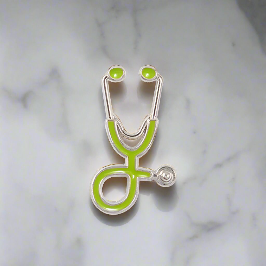 Stethoscope lapel pin displayed on a white dress shirt, highlighting its elegant design.