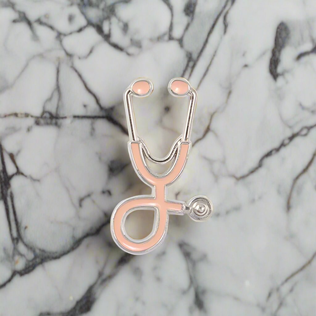 Stethoscope lapel pin displayed on a white dress shirt, highlighting its elegant design.