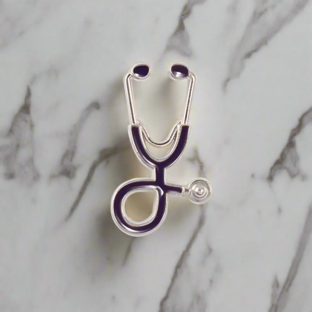 Stethoscope lapel pin displayed on a white dress shirt, highlighting its elegant design.
