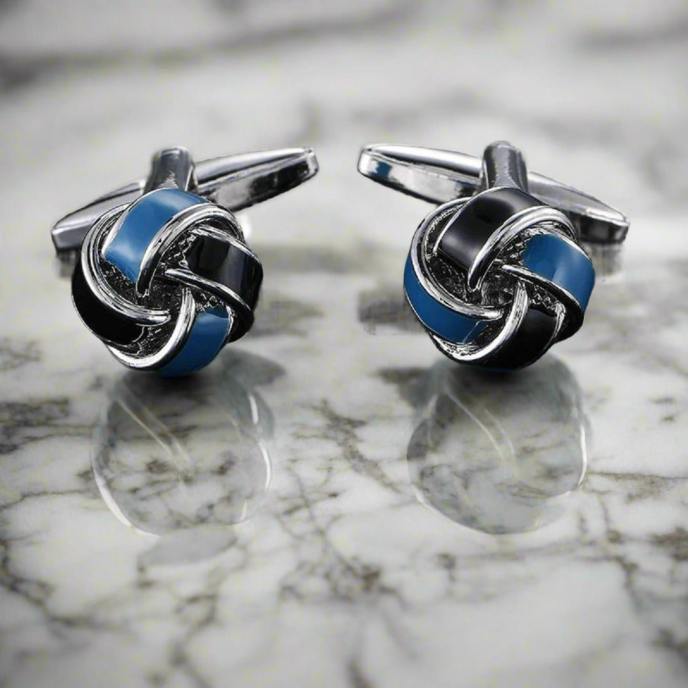 Elegant Knot Cufflinks showcasing textured silver and blue center from a side angle.