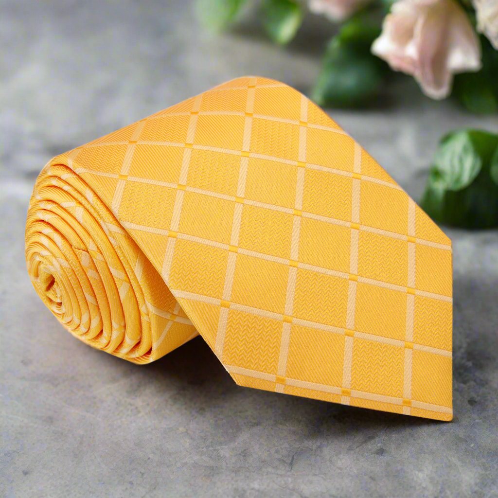 Close-up of yellow silk necktie with geometric diamond texture, ideal for formal events.