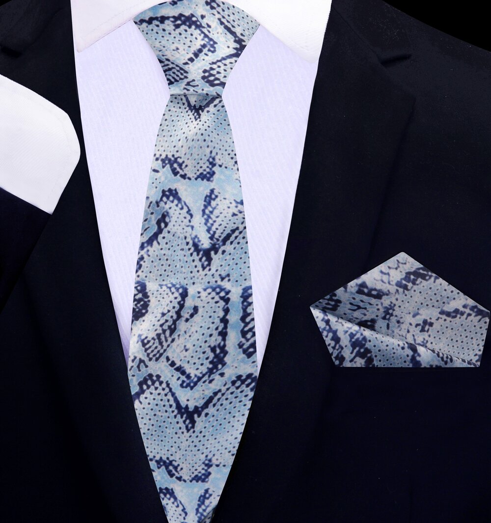 Elegant grey snakeskin necktie styled with a charcoal grey suit, perfect for formal events.