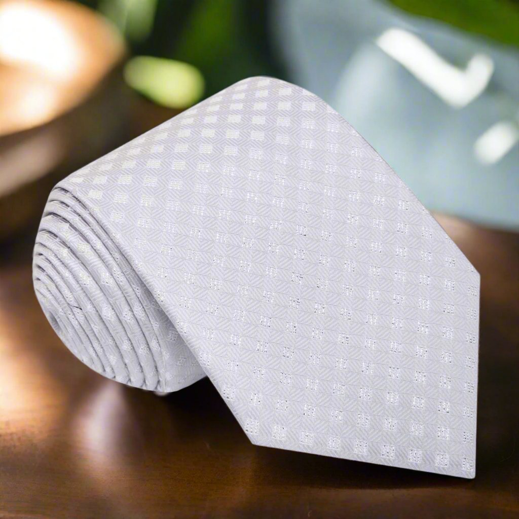 Elegant silver geometric silk necktie styled with a matching pocket square