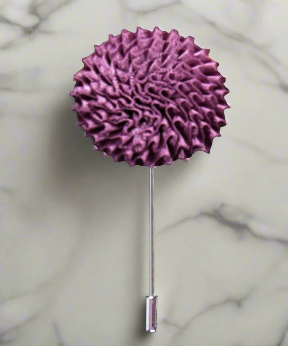Vibrant burst fabric lapel pin with colorful floral design on a blazer