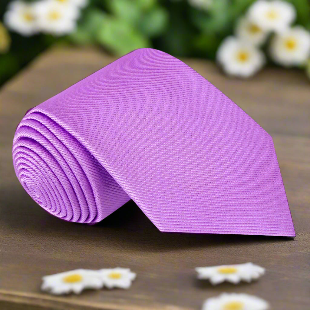 Elegant soft purple silk tie displayed on a crisp white shirt, showcasing its versatility for formal occasions.