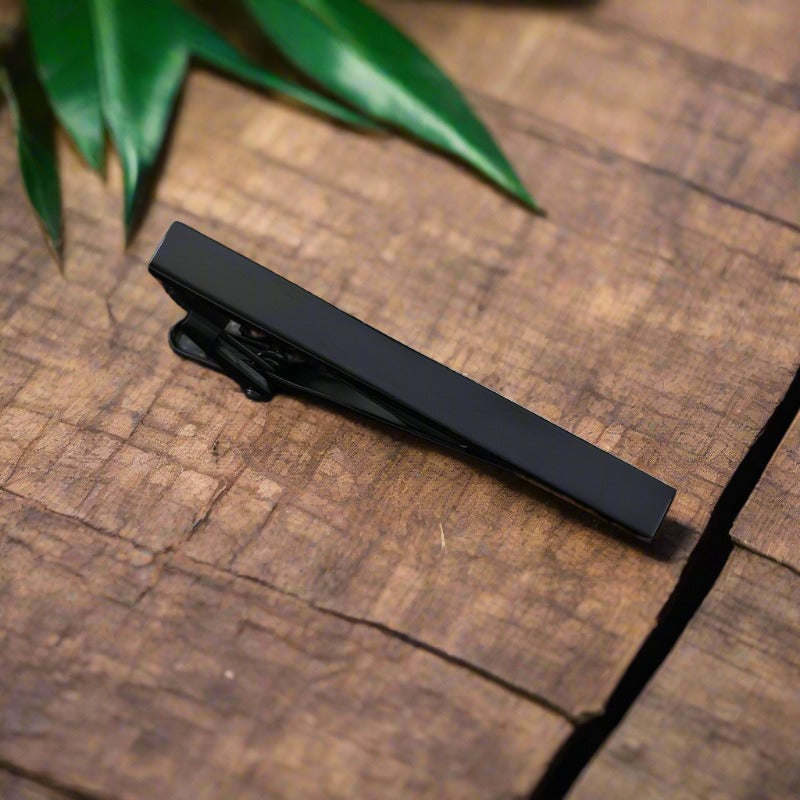 Zebra pattern tie bar with stone accents, ideal for a unique and stylish look.