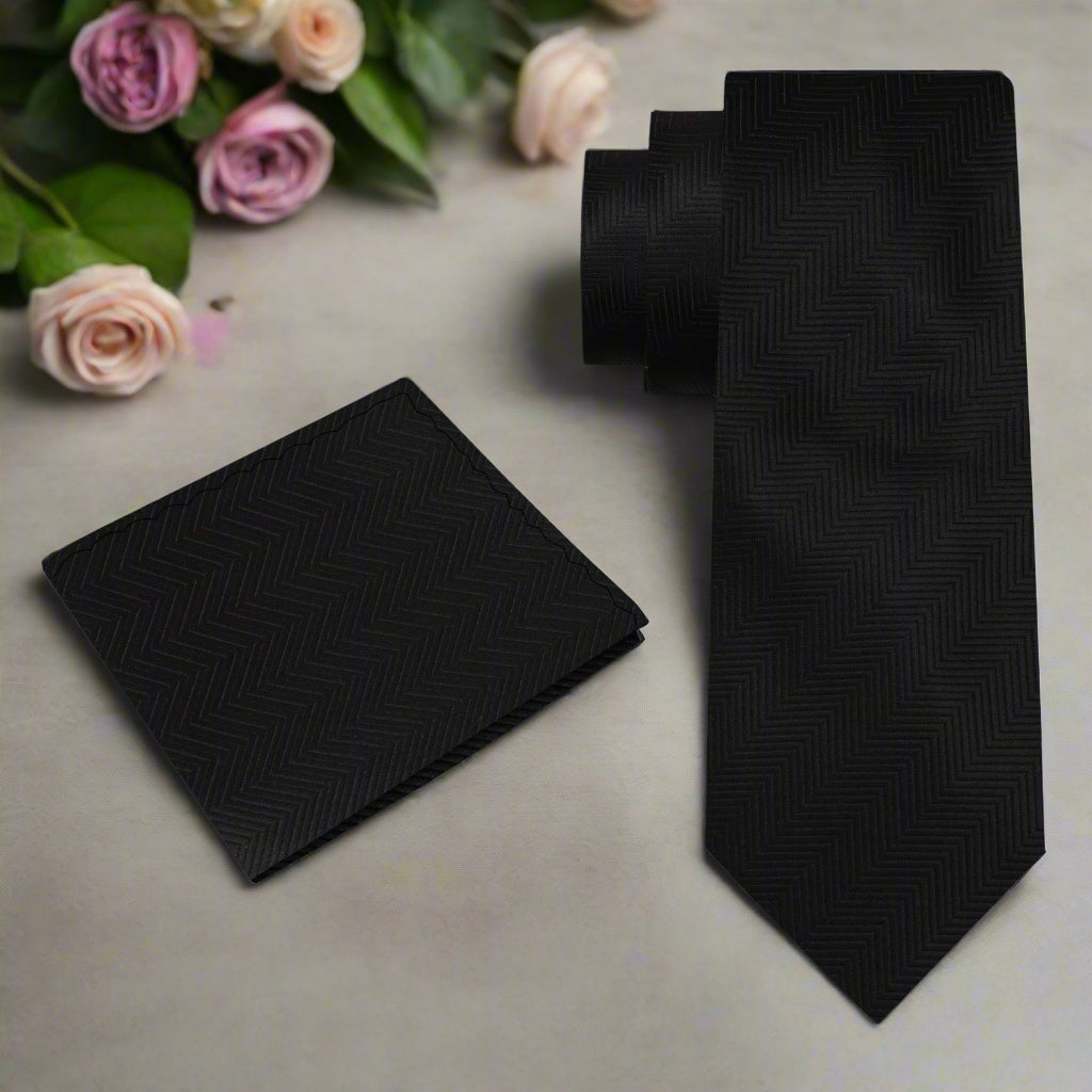 Black silk necktie paired with a crisp white dress shirt, ideal for a formal dinner.