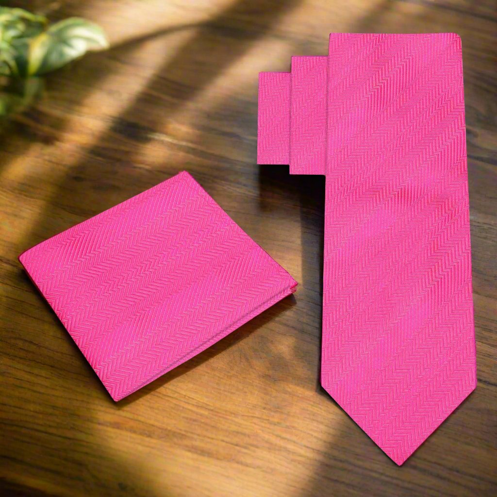 Elegant pink silk necktie displayed on a white dress shirt, showcasing the lined texture.
