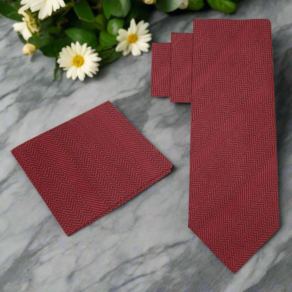 Elegant Garnet Red Silk Necktie displayed with a white dress shirt and charcoal grey suit.