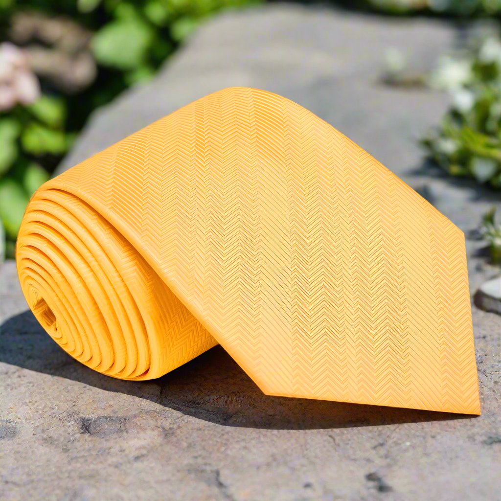 Close-up of vibrant yellow silk necktie against a crisp white dress shirt.