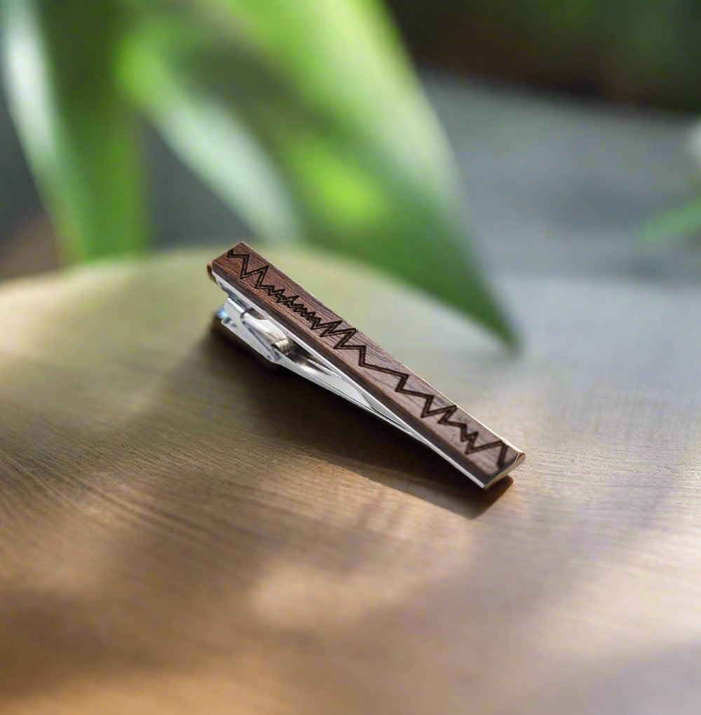 Stylish men's wooden and metal tie clip on a white dress shirt
