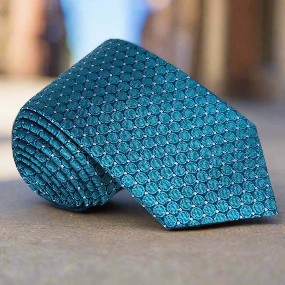 Ivy Hill luxury silk tie showcasing a geometric circles pattern in shades of blue, perfect for evening events.
