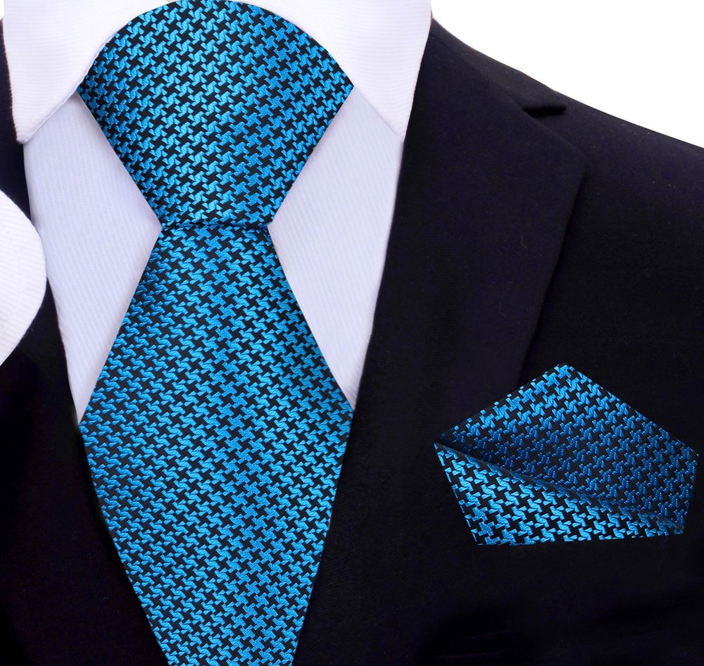 Close-up of metallic gold and black houndstooth silk necktie showcasing intricate pattern