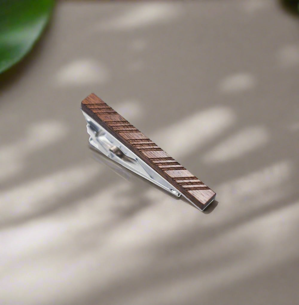 Close-up of a rustic wood tie clip with a sleek metal finish