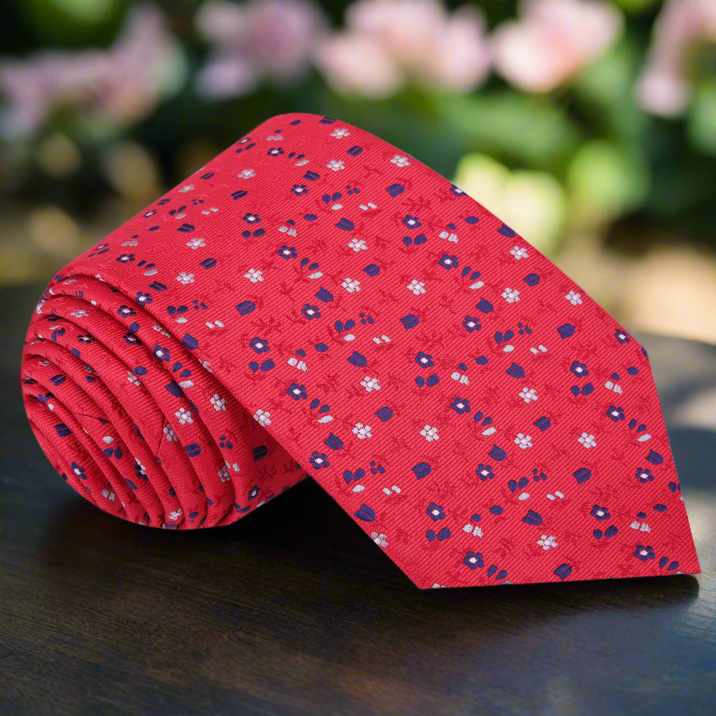 Front view of the charming red necktie with small blue and white flowers.