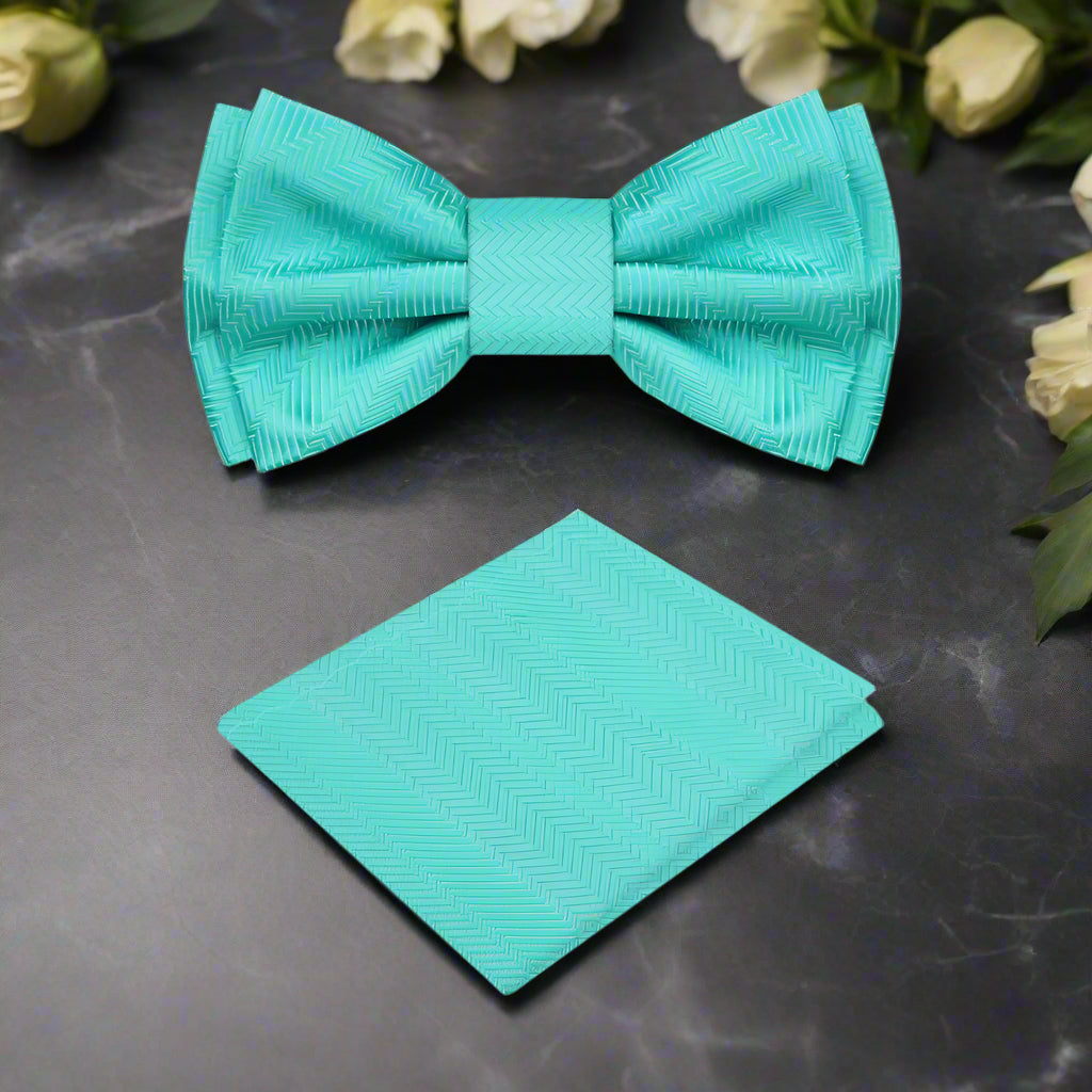 Model wearing blue silk bow tie with charcoal suit at wedding reception