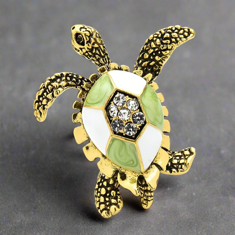 Colorful exotic animal pins with gemstones displayed for gift ideas