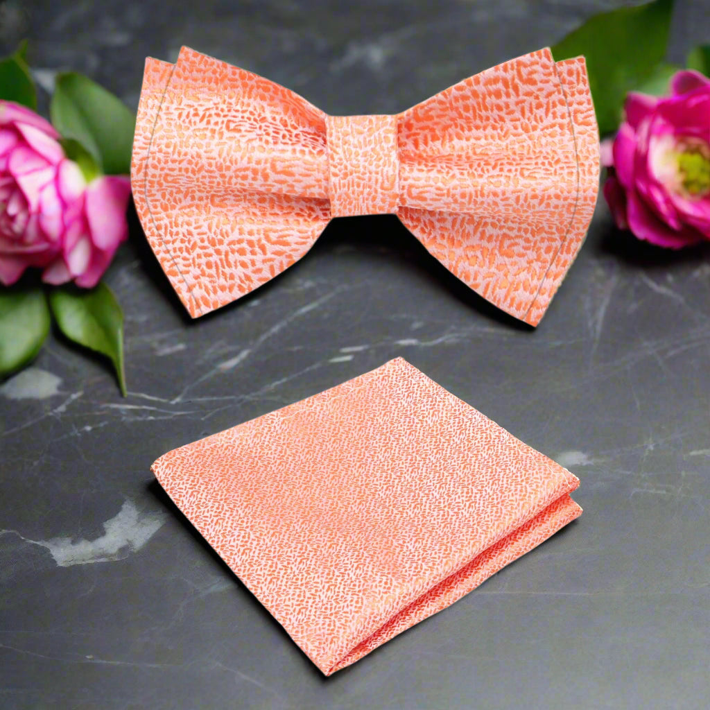 Styled image of a pink textured bow tie paired with a light blue shirt, perfect for outdoor gatherings.