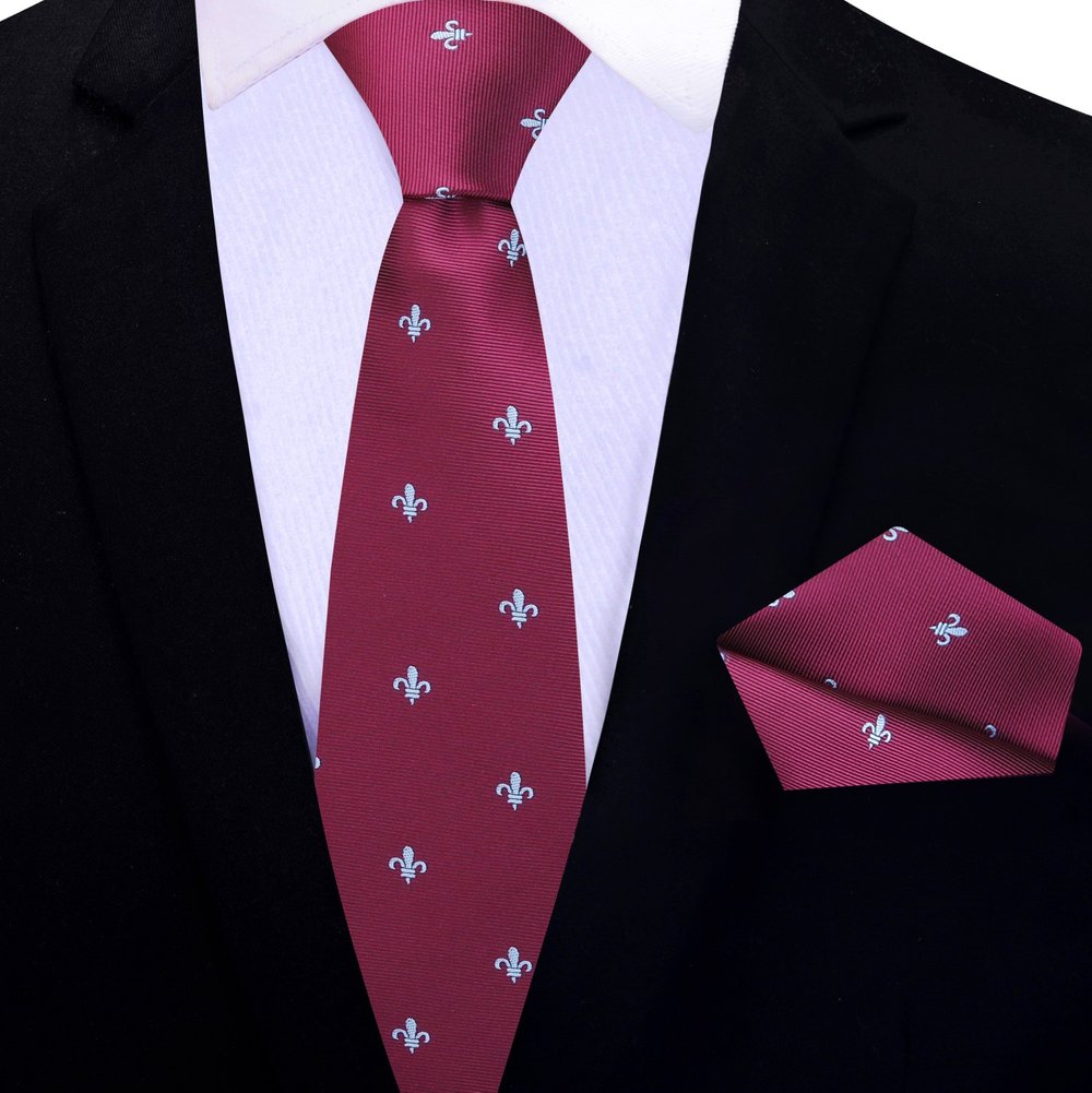 Deep red silk necktie styled with a charcoal grey suit for formal wear.