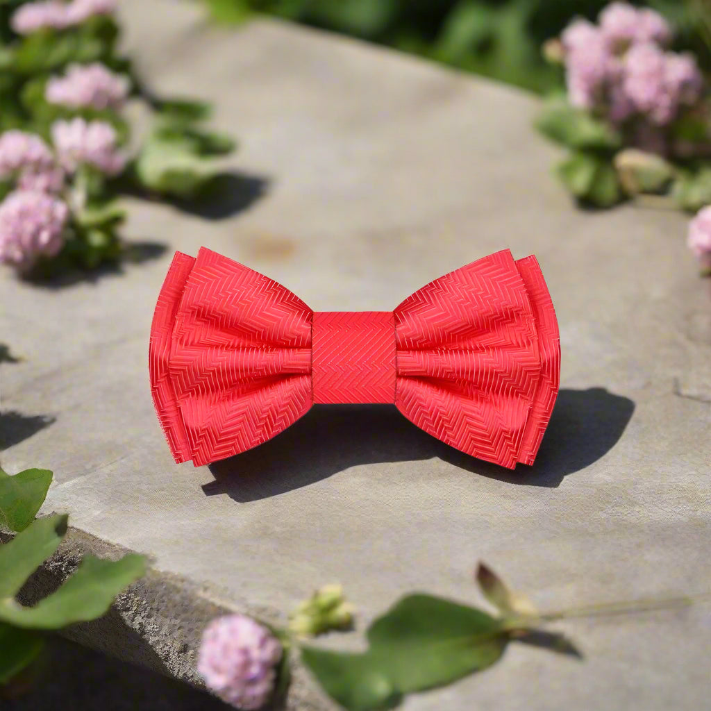 Close-up of the garnet red silk bow tie showing its luxurious fabric and solid lined texture.