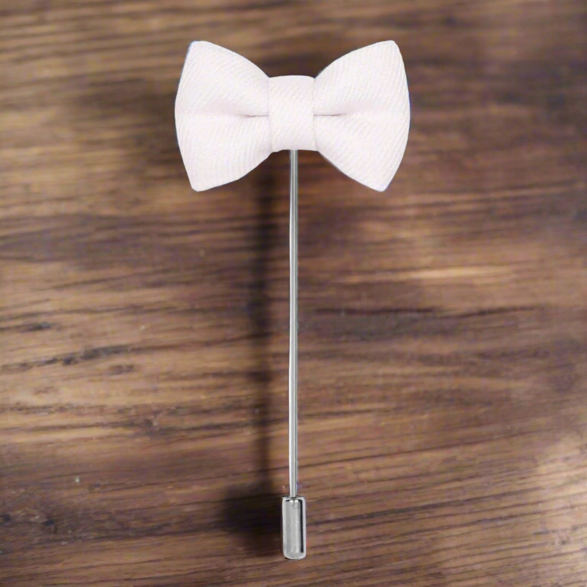 Close-up of the charming bow tie lapel pin showcasing its elegant design, ideal for enhancing suits.