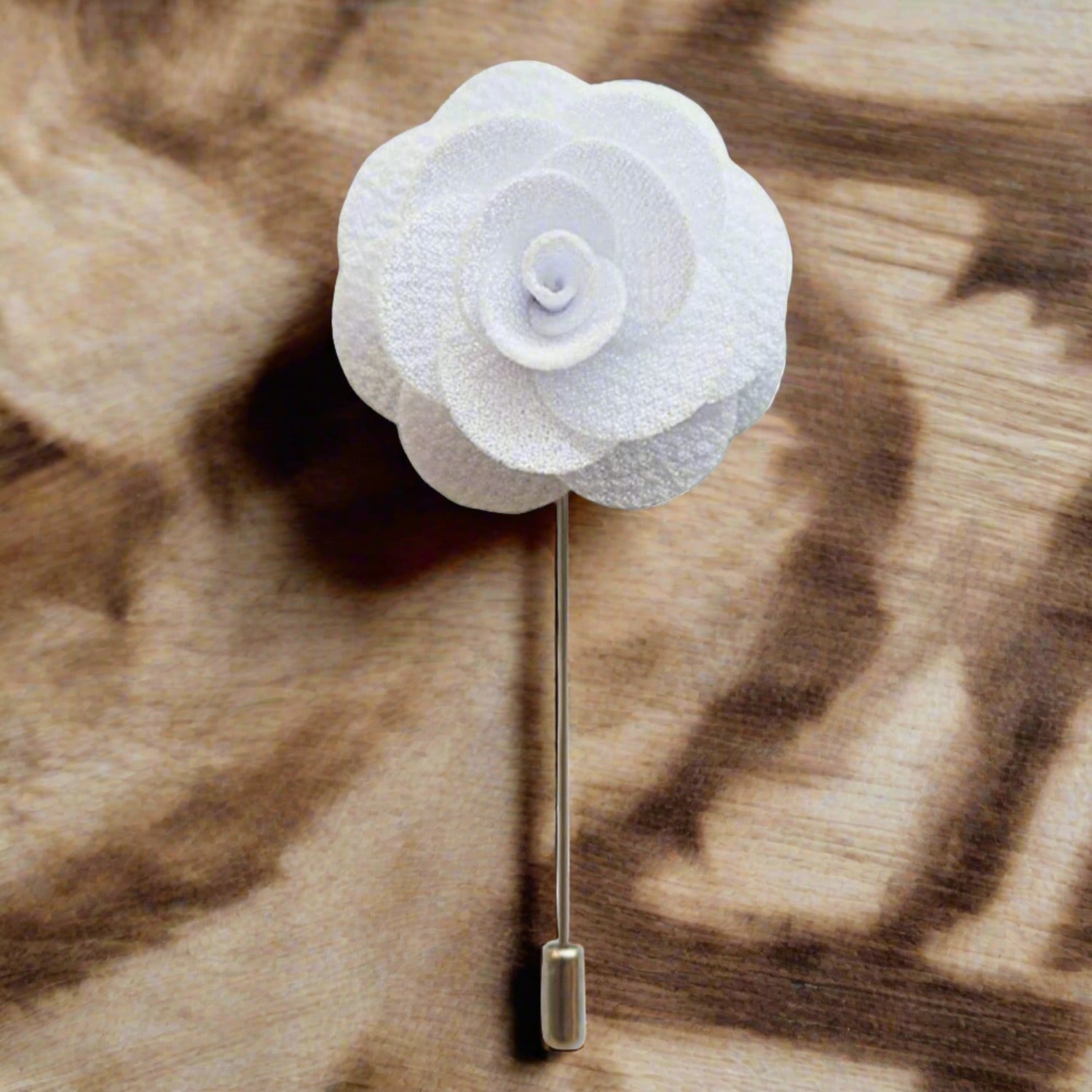 Close-up of a navy blue flower lapel pin highlighting the layered petals and polished alloy clasp