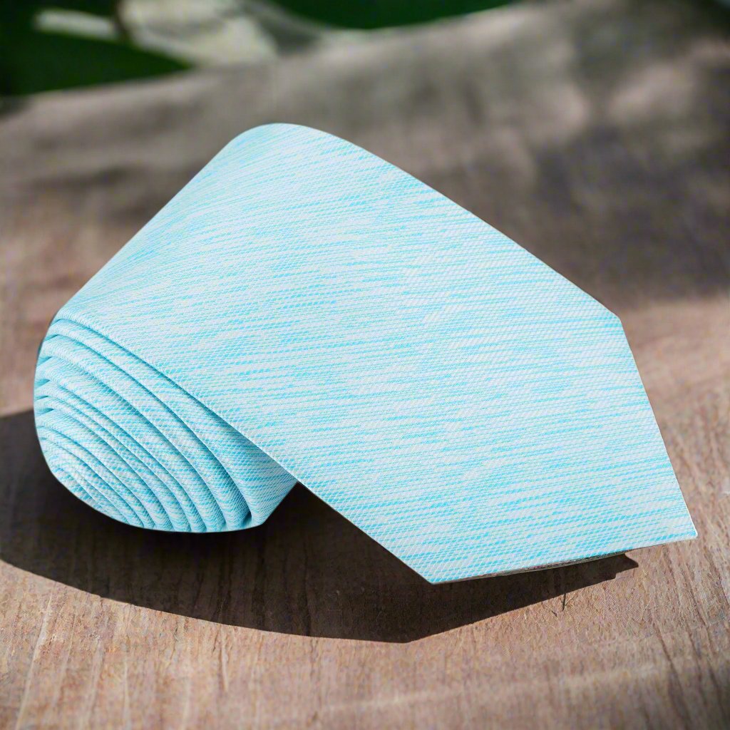 Close-up of light blue silk necktie with abstract lined pattern for formal occasions