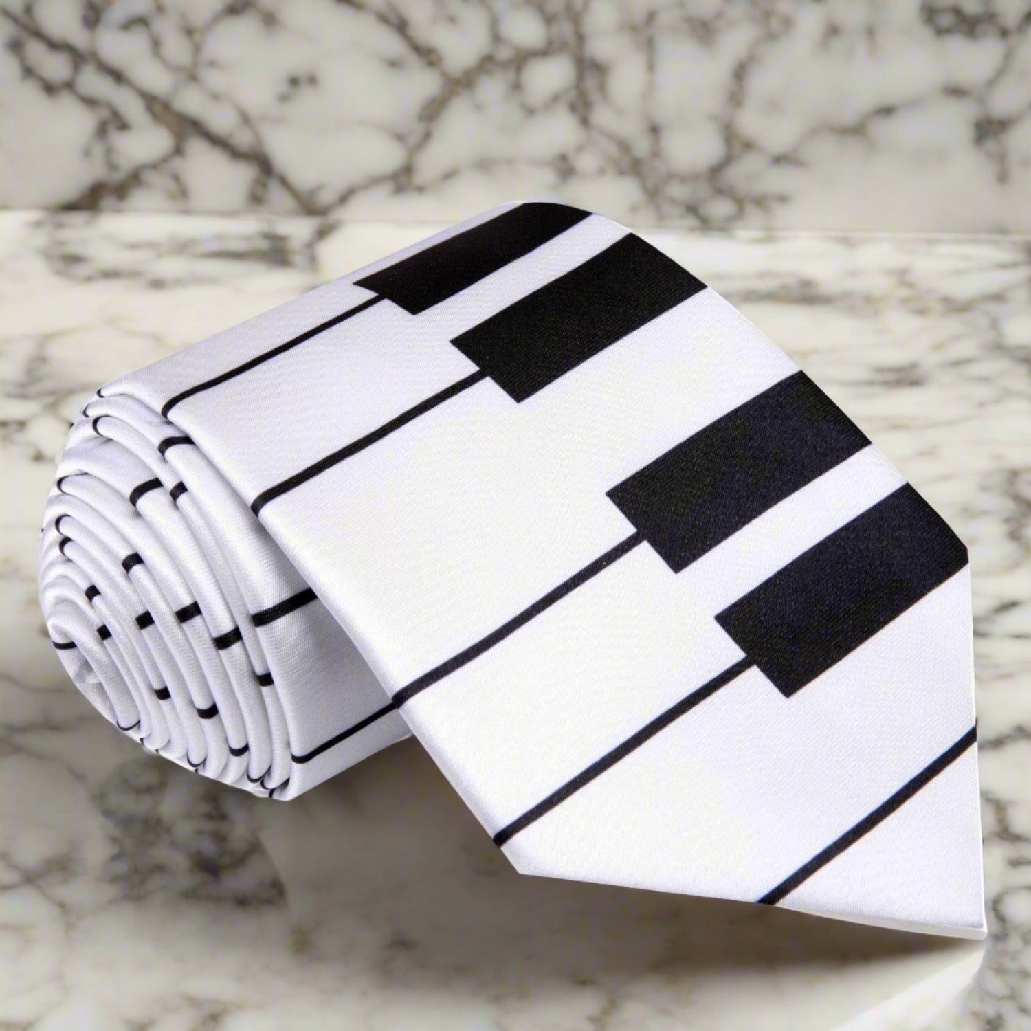 Elegant black and white piano keys necktie displayed on a dress shirt.