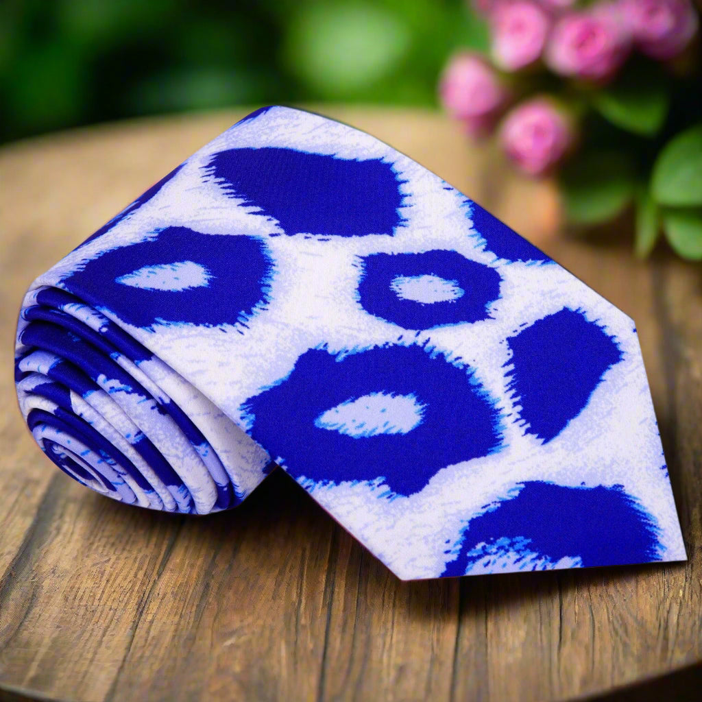Close-up of Frostwyke silk tie showing blue leopard pattern on white background