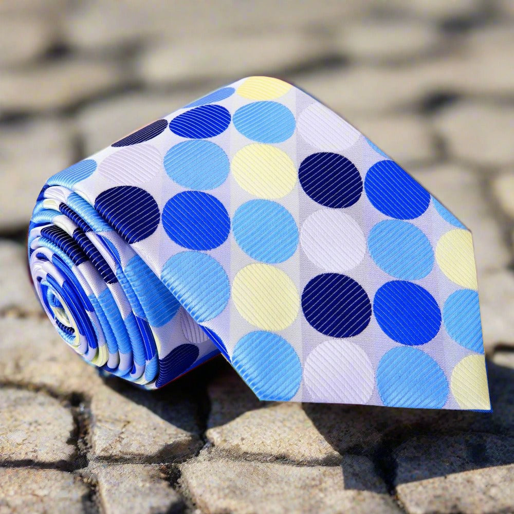 Close-up of the vibrant polka dot silk necktie, emphasizing the texture and quality of the fabric.