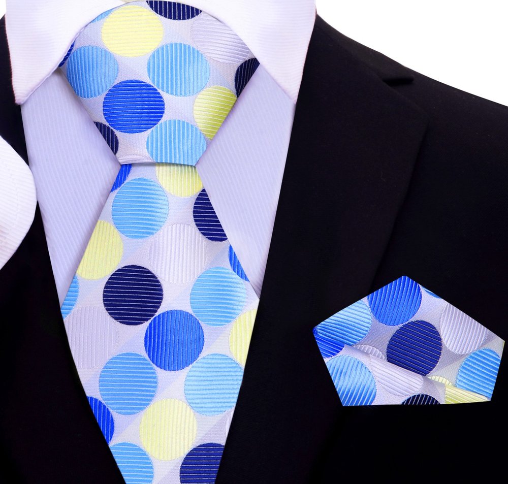 Man wearing a colorful polka dot tie at a wedding, displaying a stylish and confident look.