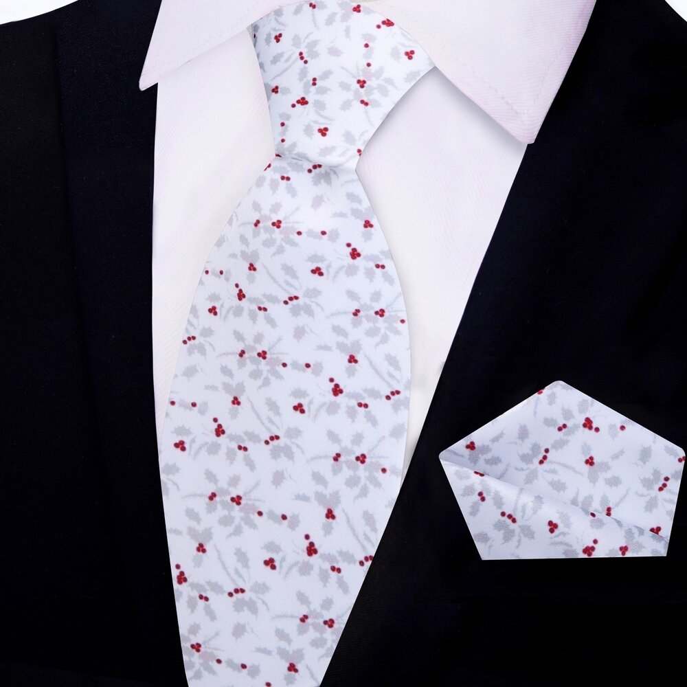 Man wearing the Christmas holly berry necktie with a navy suit at a holiday party.
