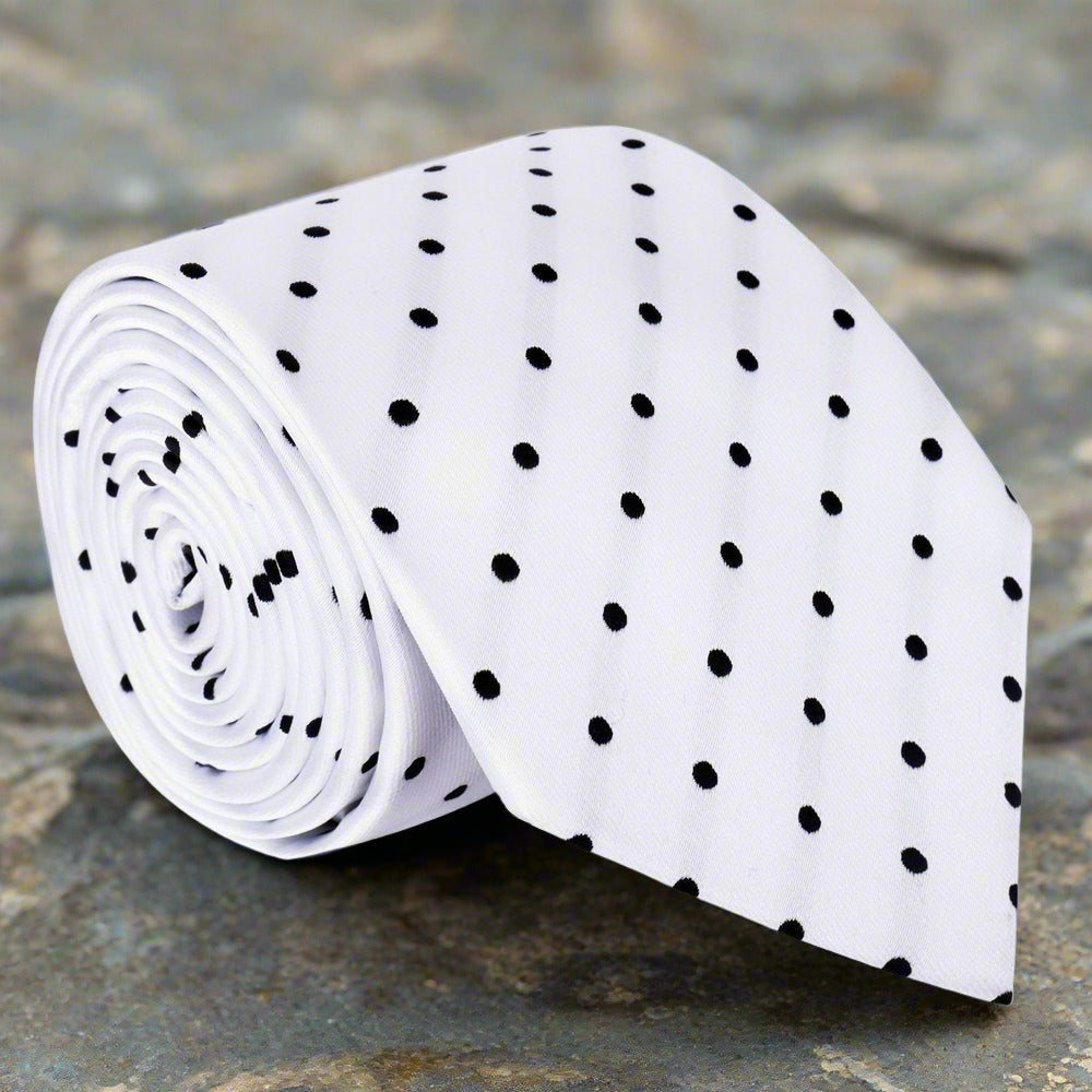 Man wearing a stylish polka dot silk tie with a navy suit at a formal event