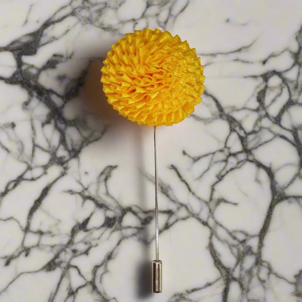 Vibrant burst fabric lapel pin with colorful floral design on a blazer