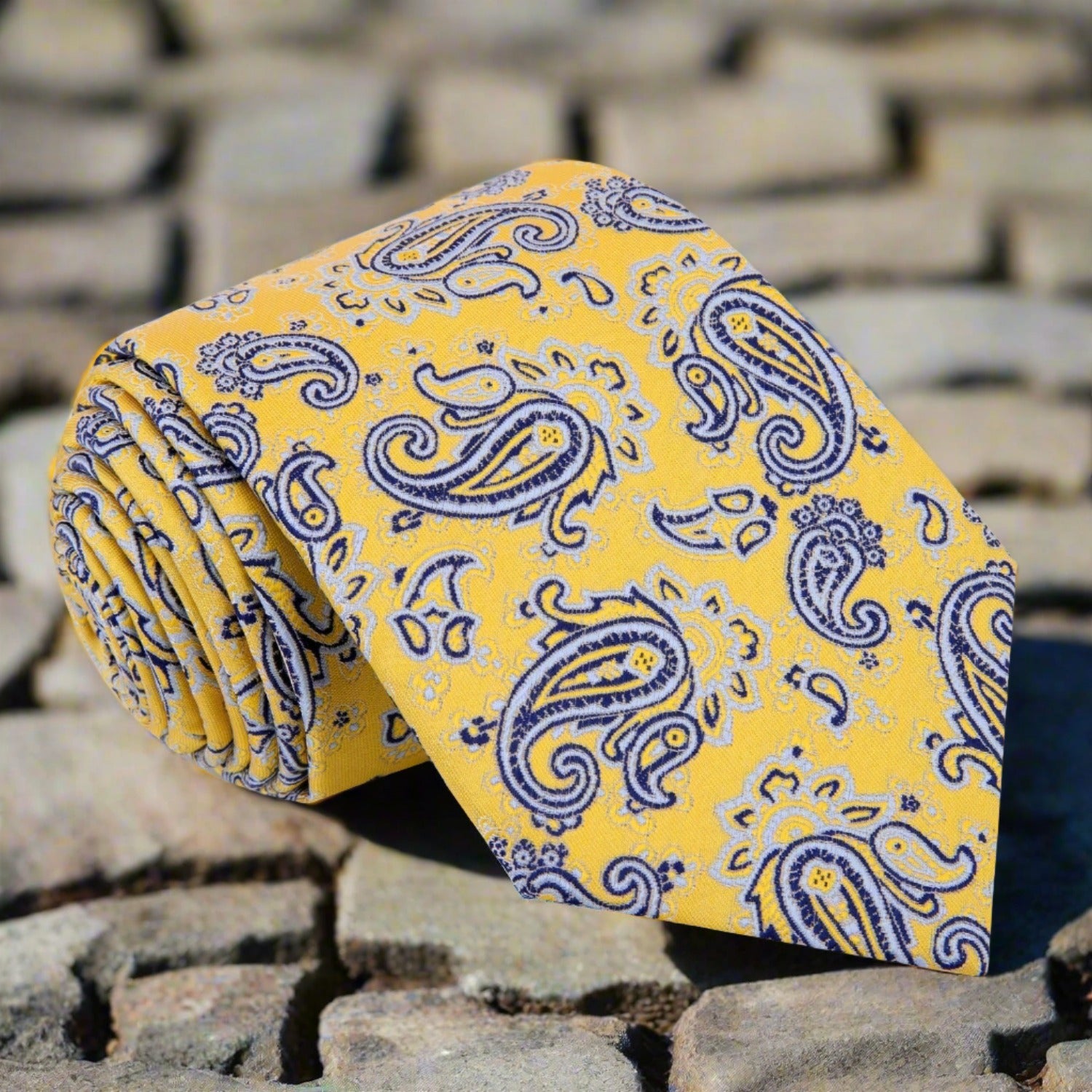 Close-up of stylish paisley silk necktie in yellow and black for formal events