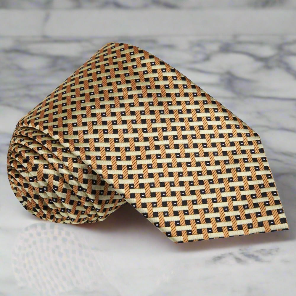 Close-up view of the elegant gold silk necktie showcasing its geometric pattern.
