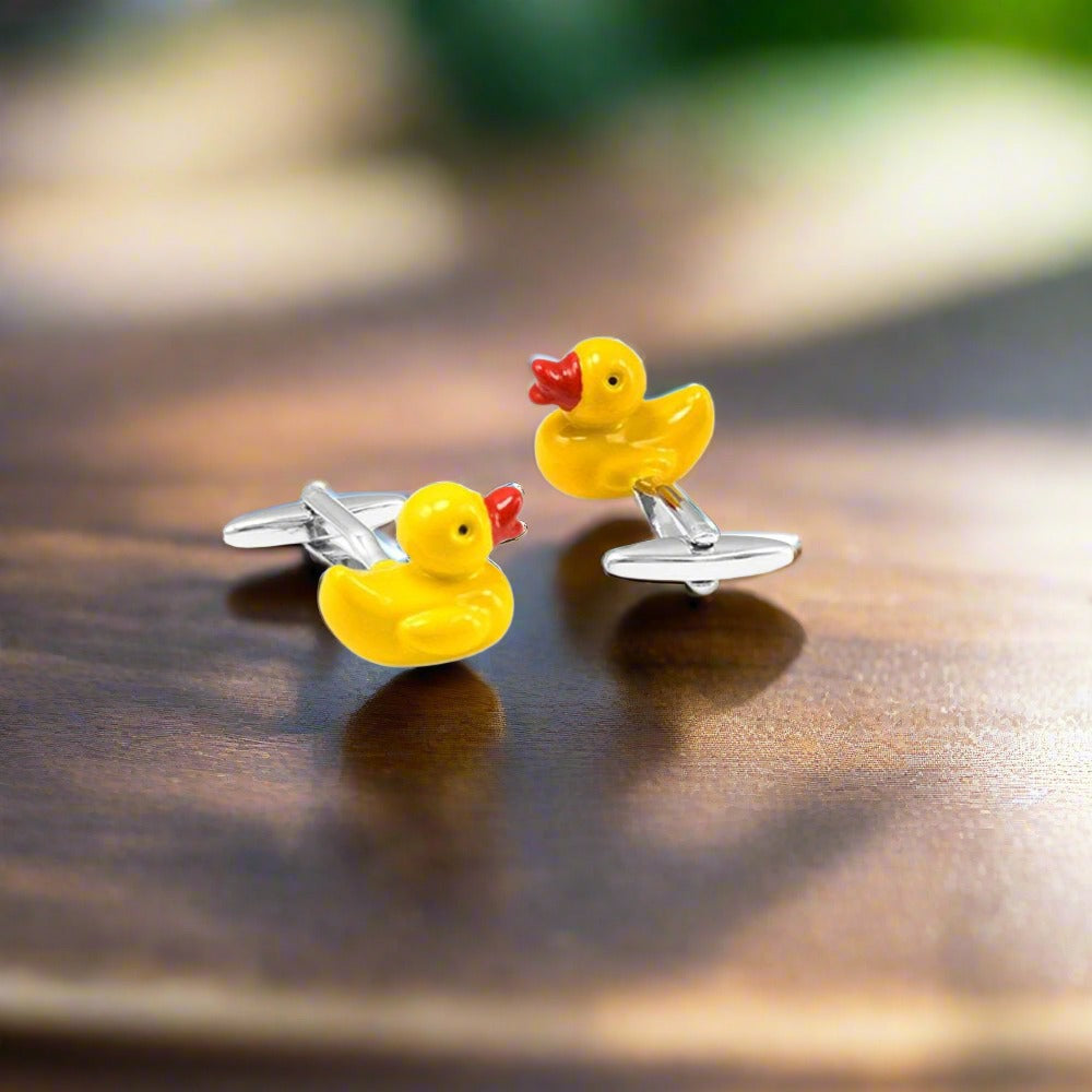 Close-up of yellow rubber ducky cufflinks on a white dress shirt for fun accessories