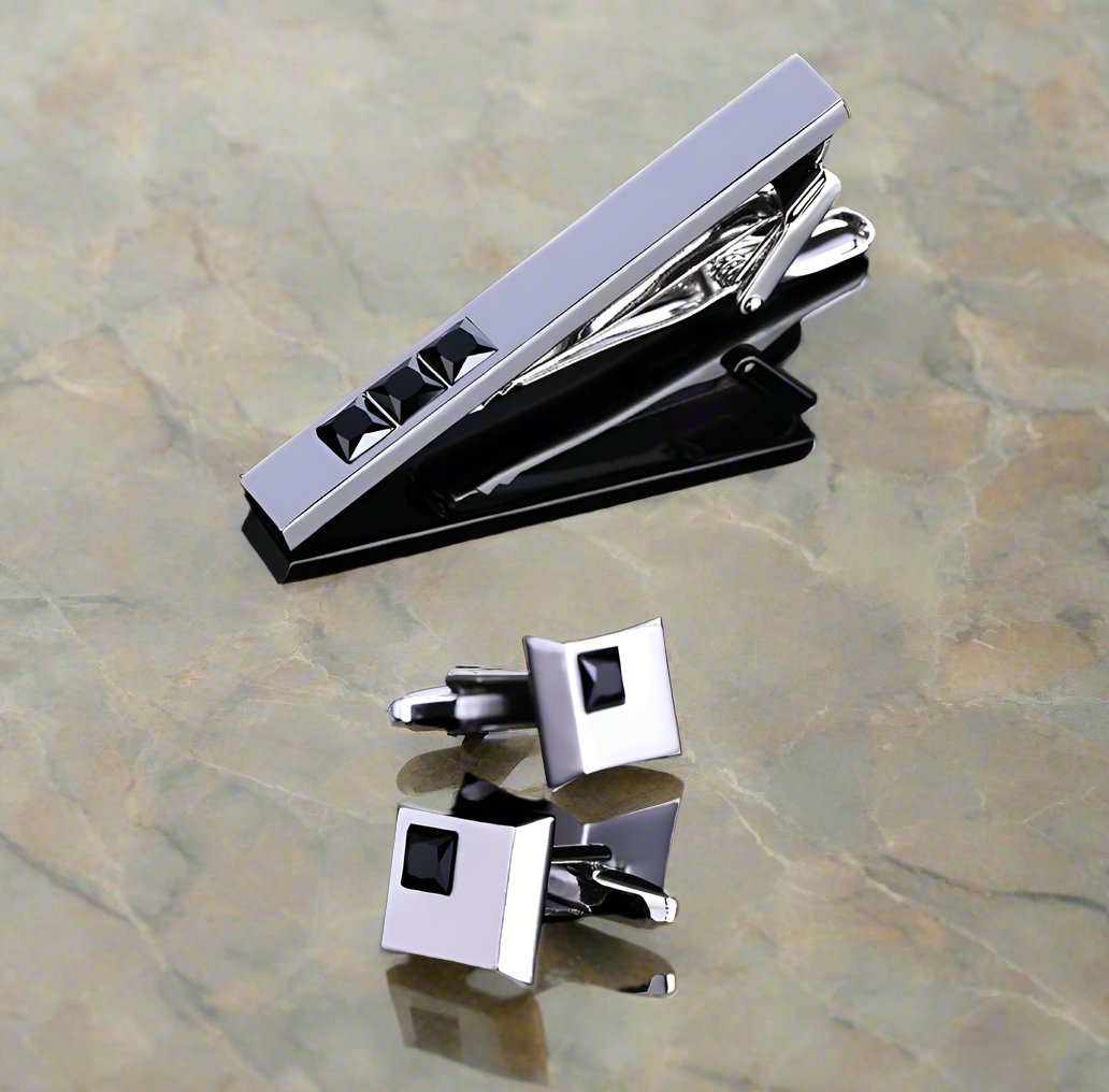 Close-up of Blackstone tie clip and cuff links set highlighting the chrome finish and black rectangle stones.