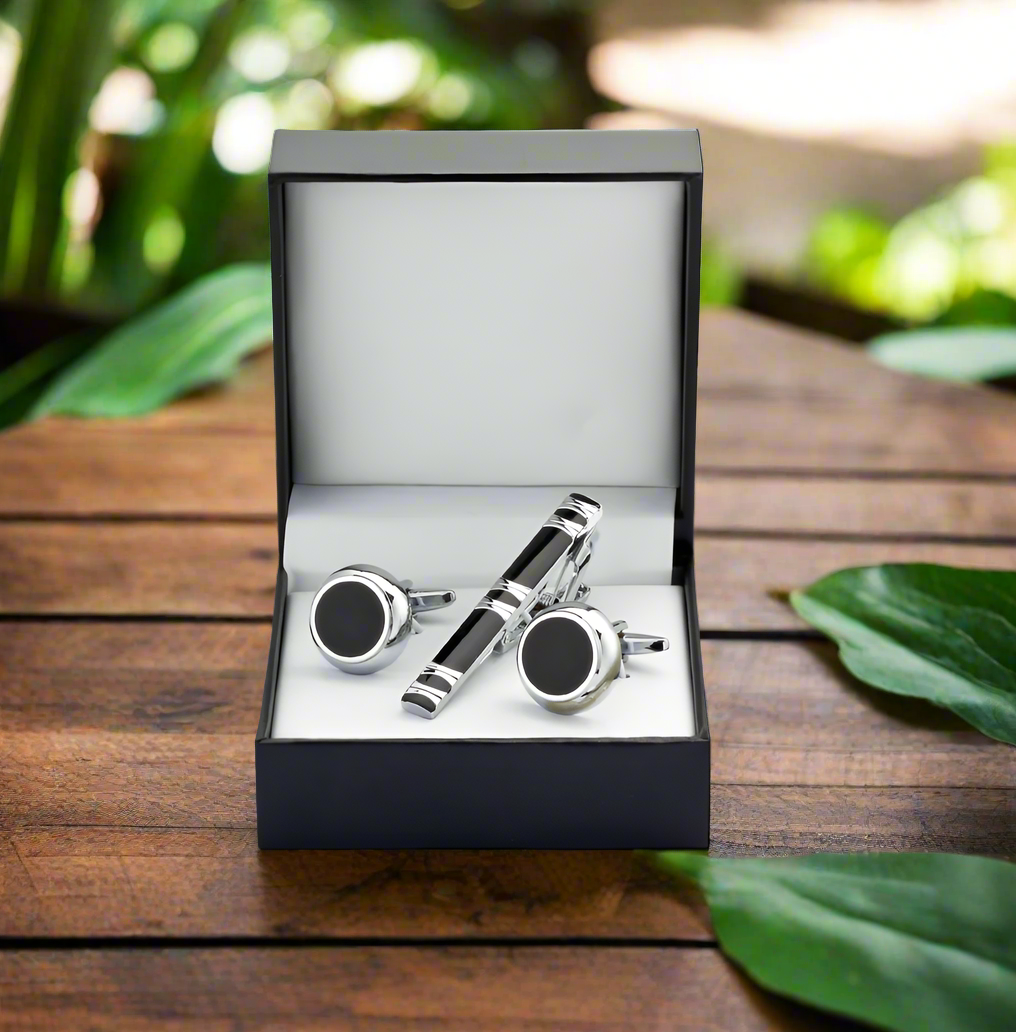 Sleek tie bar and cufflinks set displayed on a formal shirt