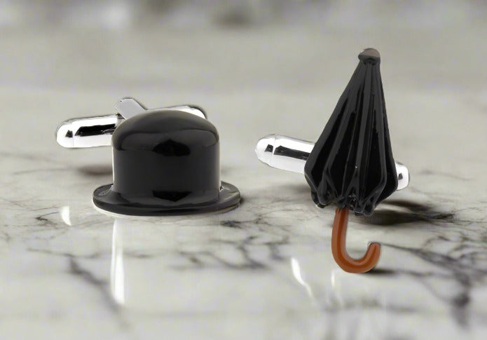 A close-up of the top hat and umbrella cufflinks resting on a white dress shirt sleeve — whimsical cufflinks for formal occasions.