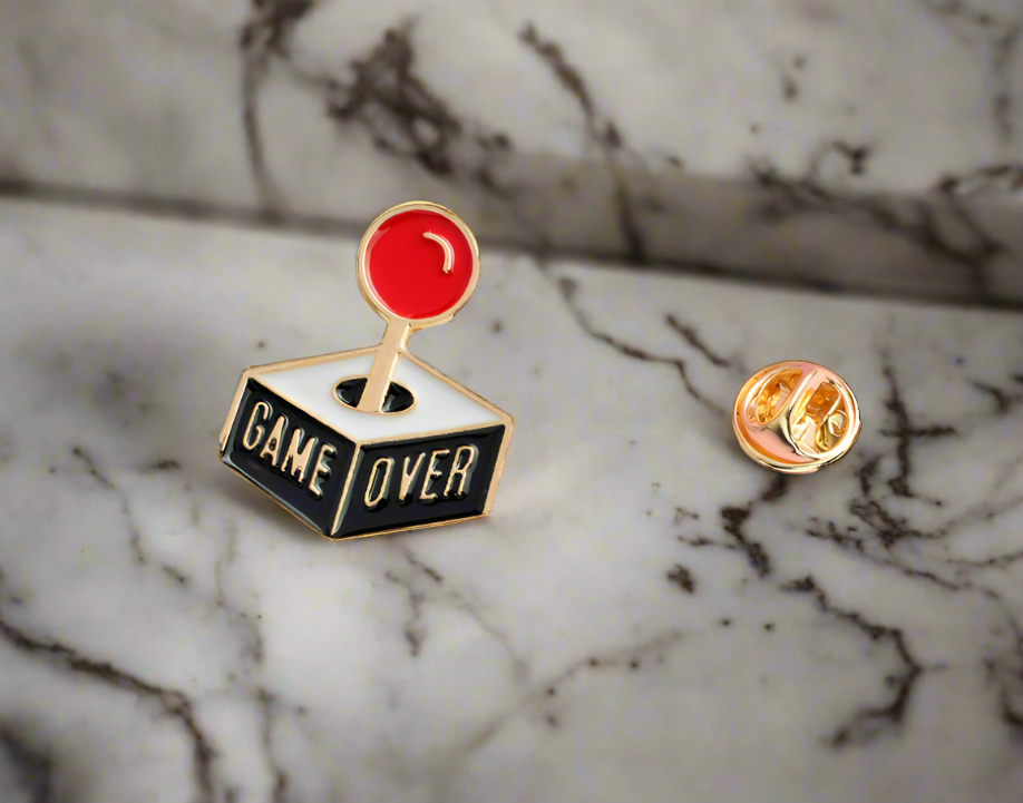 Close-up of the Game Over joystick lapel pin on a dress shirt.