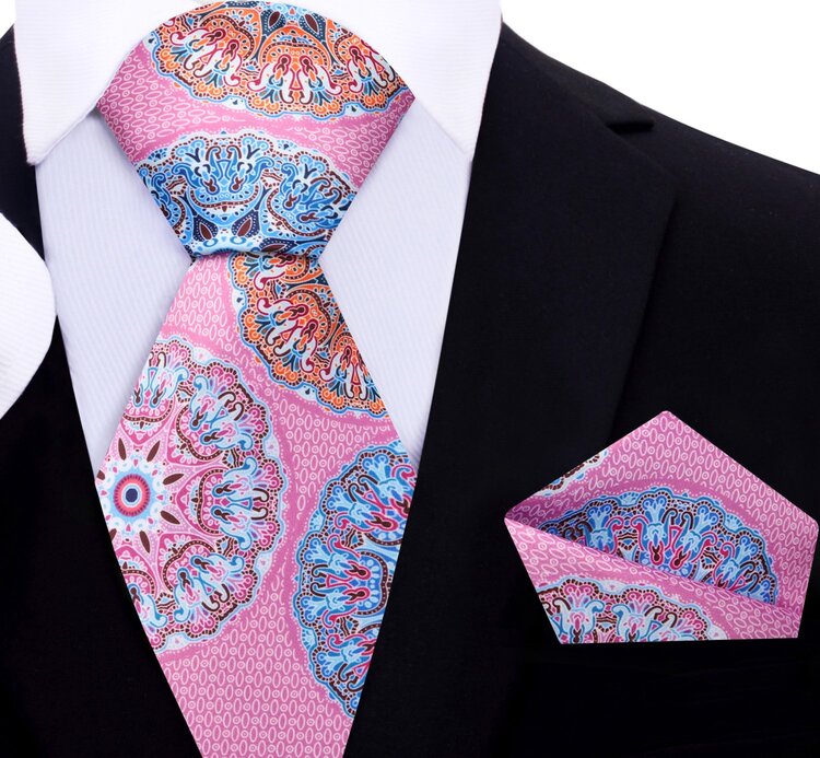 The designer tie styled with a navy blue suit, highlighting its contrast and visual pop