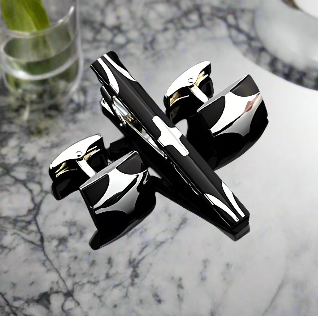 Close-up of the chrome tie bar and cufflinks set showcasing the X shape design.
